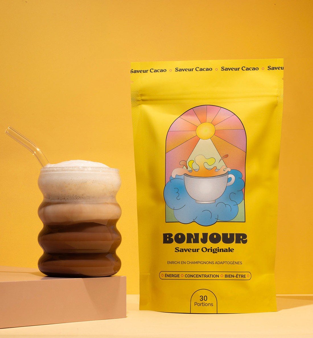Bonjour Saveur Originale pouch beside a tall iced chocolate drink