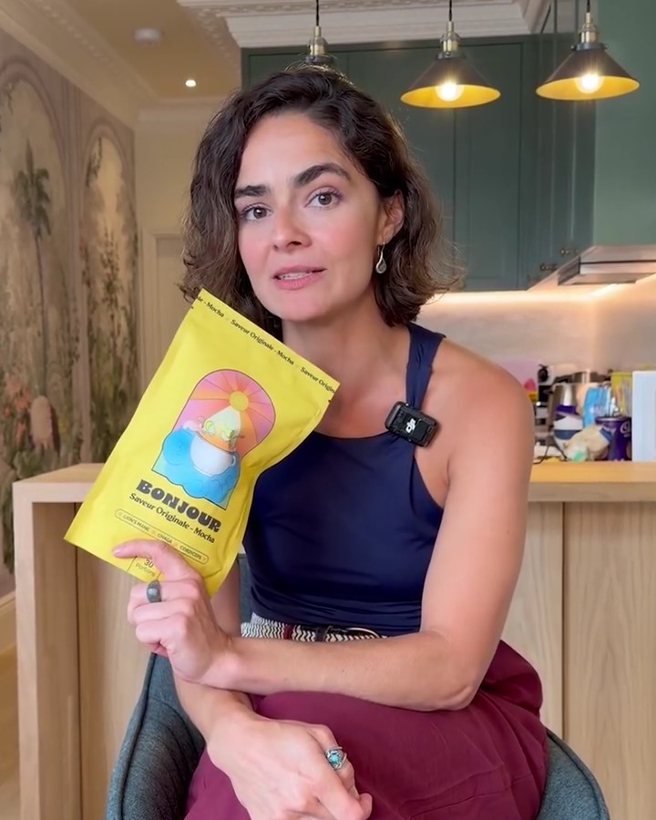 Bonjour co-founder holding a yellow Bonjour pouch in a home kitchen